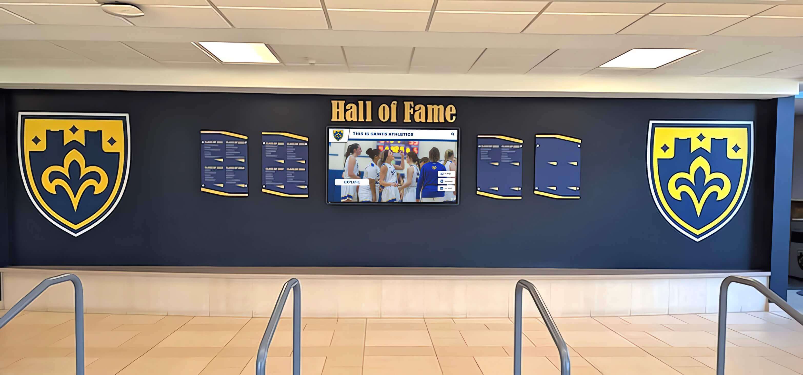 Digital display integrated into traditional hall of fame wall Athletic records touchscreen in trophy case