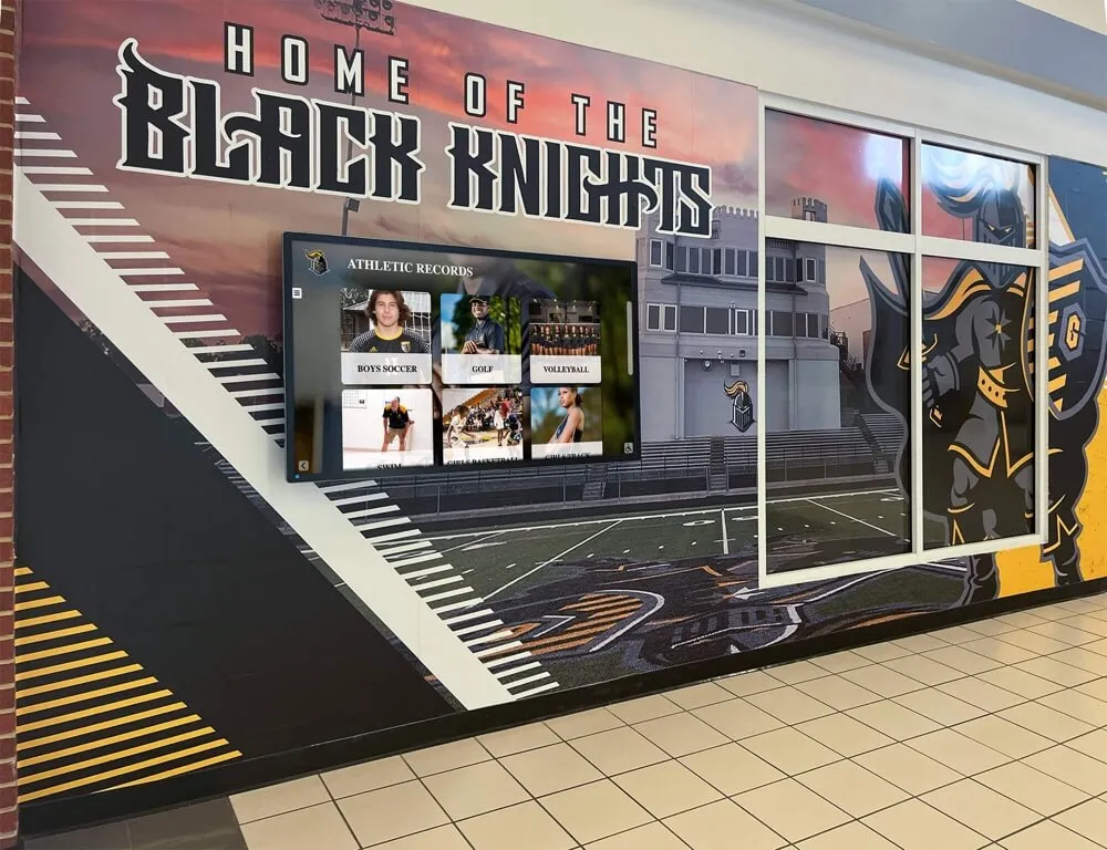 School hallway with Black Knights mural and display