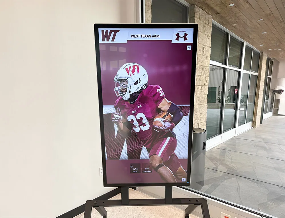 Digital display featuring football player profile Football player display in university lobby
